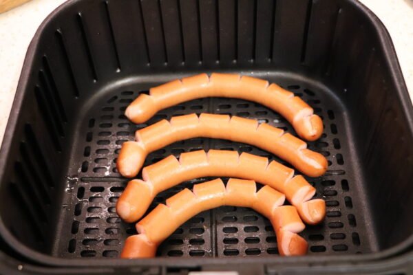 sausage frying in airfryer frying after